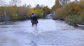 Man on TRICYCLE tackles floods in West Yorkshire, England