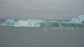 Large chunk of melting glacier in Iceland seen sliding into sea