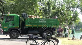 Workers clean away rubbish left in lake from Buddhist Loi Krathong festival