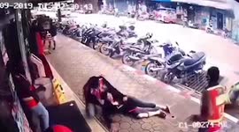 Thai woman survives after 22,000 volt power line falls on her outside grocery shop