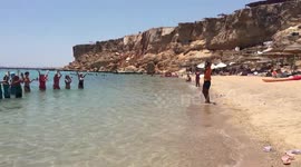 Exercise Trainner Helps Italian Tourists Doing Some Warm Ups In Water