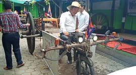 Salesman has wacky bicycle trailer cart In Cambodia