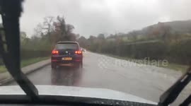 UK man drives through flooded road on his way to work