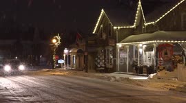 Pretty snow falling at night on Mainstreet Unionville Markham near Toronto as the historic cold and winter weather continues and makes for some early Christmas holiday scenes