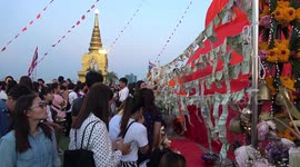 Thai Buddhists write wishes on red cloth at Golden Mountain temple
