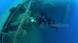 Scuba divers exploring Zenobia wreck