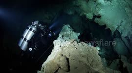 Scuba divers in a submerged cave, Mexico, Yucatan
