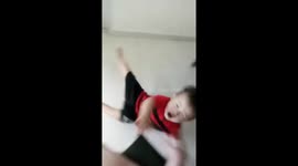 Toddler falls down while happily running toward his mom