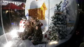 Family inside a Festive Snow globe at Christmas - Slow motion video