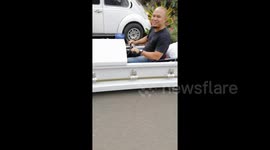 Bizarre moment Filipino motorist drives along road in a coffin-mobile