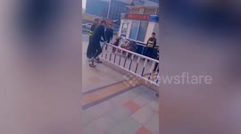Chinese men forced to repeatedly climb over guardrails by police after breaking traffic regulations