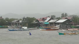 Fishermen carry on working as typhoon hits the Philippines