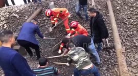 Chinese firefighters rescue worker out after he was buried in gravel due to rockslide