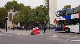 Brexiteers show leave mean leaves sign to tourist bus