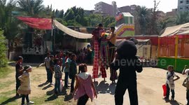 Boys Surround Cartoon Clowns In Fun Park
