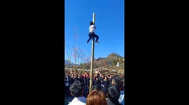 Vietnamese festival sees contestants race to climb up five-metre wooden pole