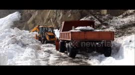 Snow trucks clear out blocked mountain roads in north India