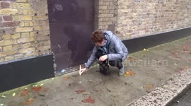Freddie Mercury fan is lighting a candle outside the Garden Lodge as visitors from around the world start paying tributes  - 28 years on
