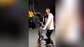 Father and daughter are perfectly in sync when jumping over skipping rope