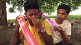 Indian man blows up a balloon with his ear