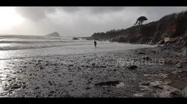Storm Sebastian Surfers heading for the waves at Wembury Devon