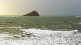 Storm Sebastian drawing in from the English Channel on to wembury beach surfers chasing the waves