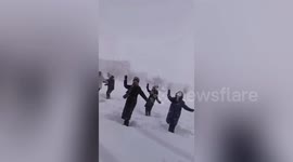 Chinese women perform dance routine in arctic conditions