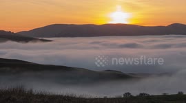 Time-lapse footage of sunset overlooking dense fog bank shrouding the Upper Eden Valley in Cumbria