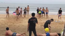 Teams of youths hold contest bursting balloons on each other's bodies