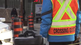 Toronto deploys crossing guards to get grown adults across busy construction filled mid-town intersection of Yonge and Eglinton