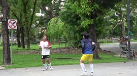 Two keep-fit enthusiasts play Sepak Takraw keepy-uppy