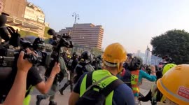 Hong Kong 1st December 2019 - Riot police charge towards protesters during a peaceful legal march in support of the five demands