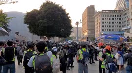 Hong Kong 1st December 2019 - Riot police throw a tear gas grenade in the busy shopping district of Tsim Sha Tsui in Kowloon