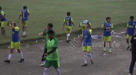 Soccer players in Indonesia dump plastic garbage by side of pitch