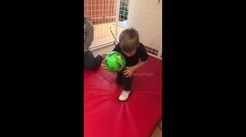 Ronnie standing up from a kneeled position with a ball