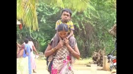 Determined mother in India has to carry disabled son 8km to school every day