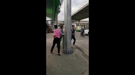 Thai policeman punishes boys caught without helmets by making them run round lamppost