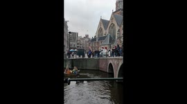 a man on a little boat duets with the church bells