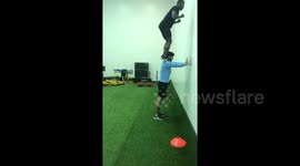 Amazing gymnast does running jump onto shoulders of 6’4 friend