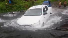 Driver gets stuck in river after Typhoon Kammuri in the Philippines