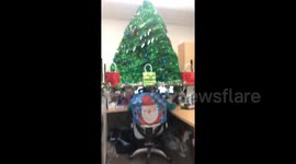 Oregon office employee gets in the festive spirit by topping her desk with Christmas tree