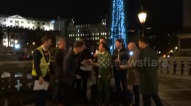 Jolly atmosphere at Trafalgar Square Christmas Tree lighting - male choir entertains visitors of Christmas Market