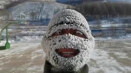 Firefighters' face masks covered in snow after they train outside in sub-zero temperatures