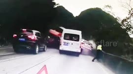 Chinese police officer jumps over wall to escape being crushed by oncoming truck