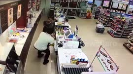 Bizarre moment robber punches shop assistant then stops to check he's OK