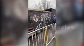 Shocking moment rival graffiti artist attempts to vandalise brand new Banksy