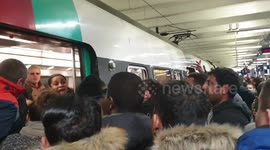 Chaotic scenes as commuters push and shove to board packed train in Paris during nationwide strikes