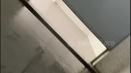 Chilling moment woman using the toilet records 'pervert peeping through gap under door'