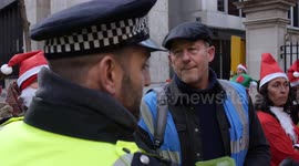Police officer confronts Extinction Rebellion activists leaving coal outside Tory HQ in London