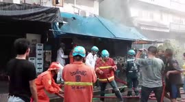 Dramatic moment fireman carries toddler out of burning building in Bangkok